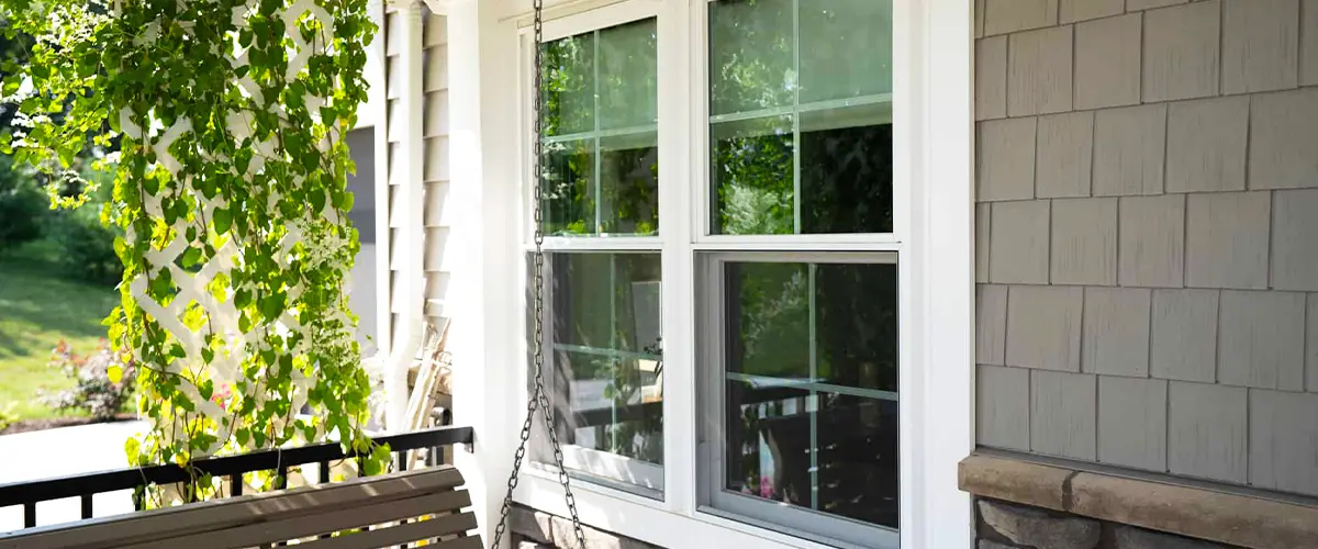 Cozy front porch with double-hung windows, enhancing curb appeal and natural light.