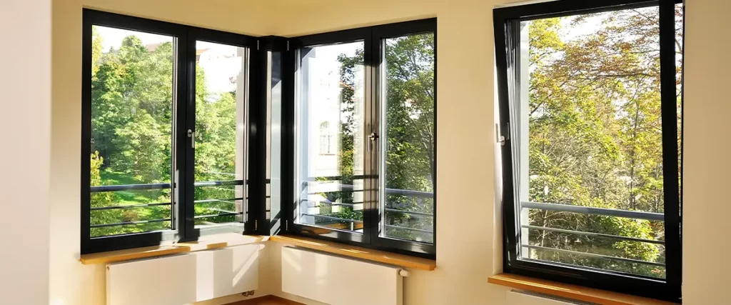 Minimalist design with modern black-framed windows providing a scenic outdoor view.