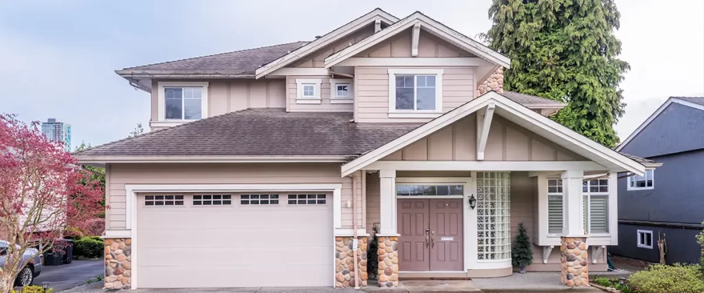 Modern suburban home exterior with garage and landscaped yard