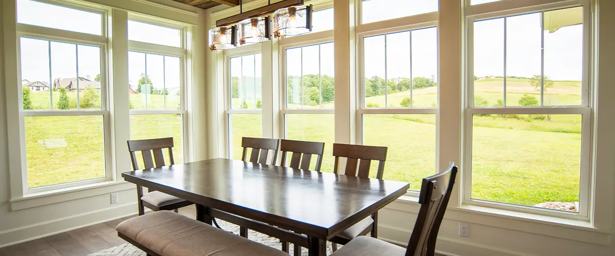 Spacious dining room with large energy-efficient windows offering scenic outdoor views.