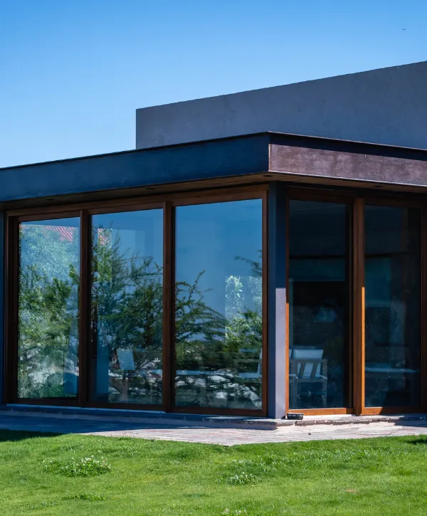 Luxury home with floor-to-ceiling glass walls, offering a seamless connection between indoors and outdoors.