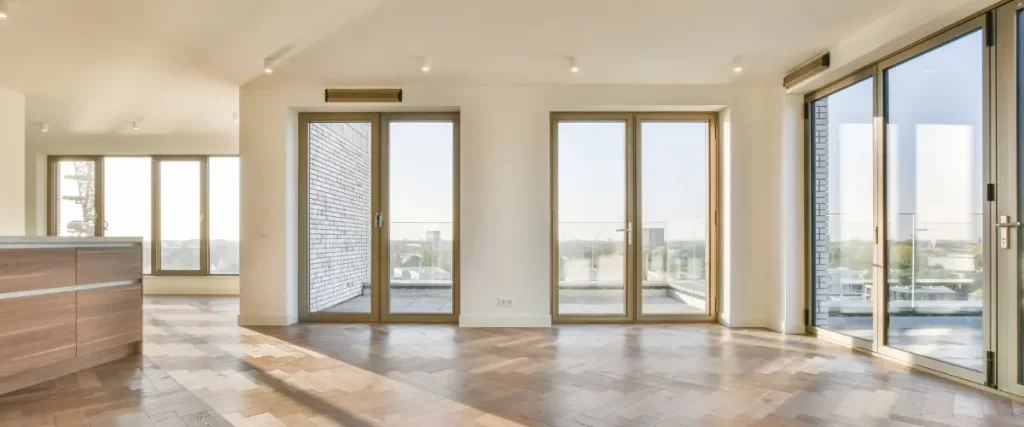 Spacious modern living room with large glass doors leading to a balcony