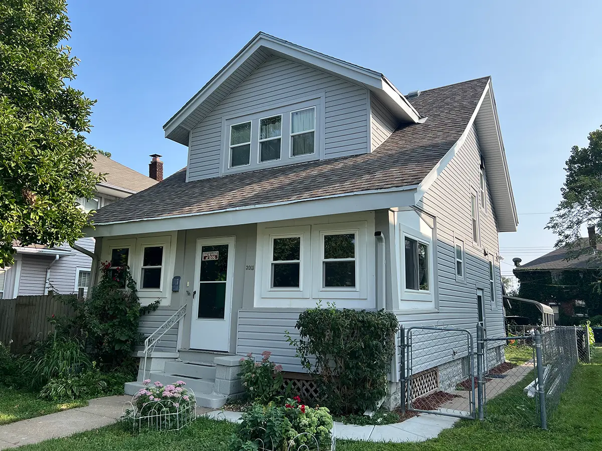 After photo of a two-story home with newly installed siding, enhancing its curb appeal with a clean, inviting appearance from HomeGeneral in Nebraska