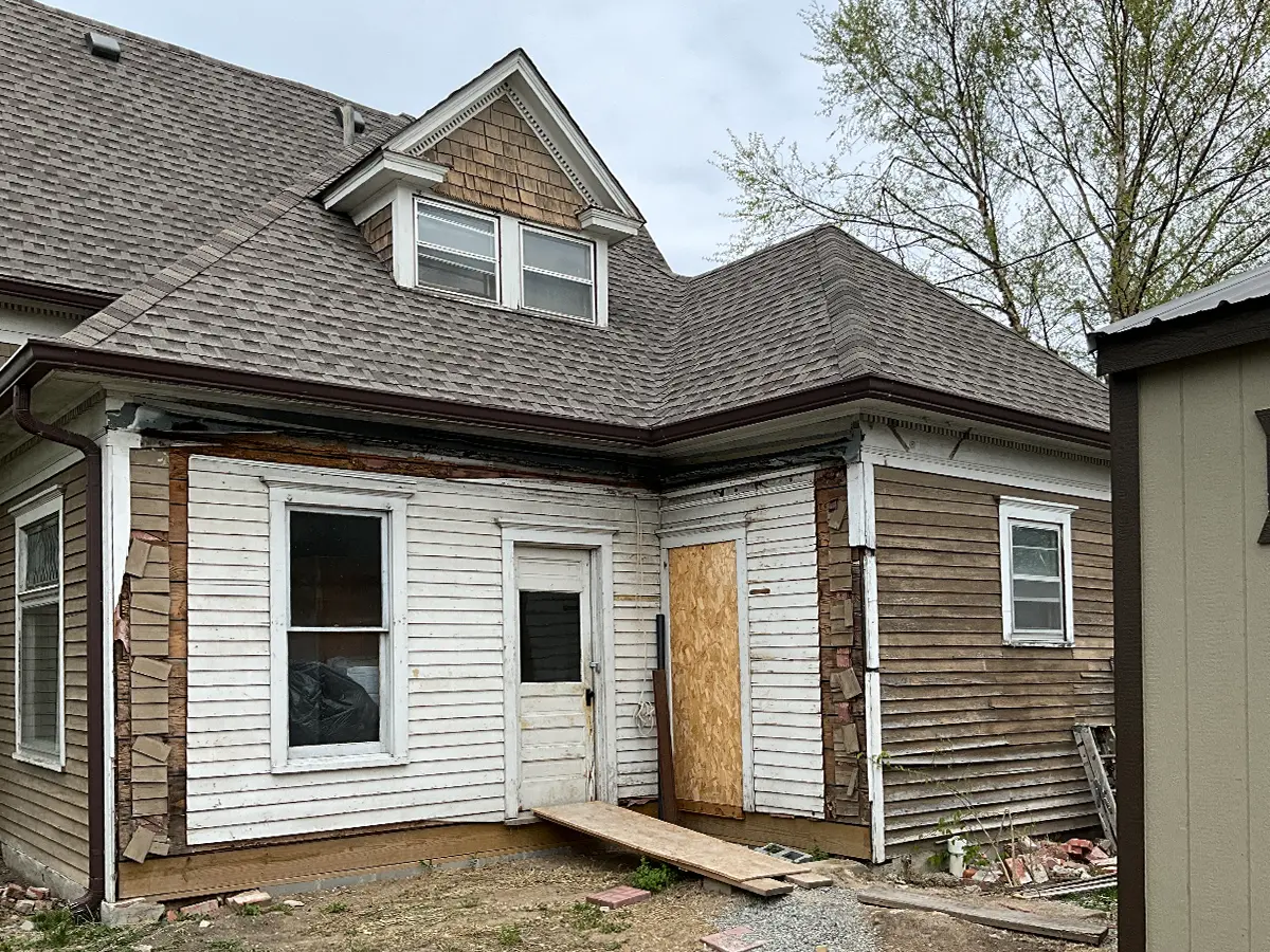 Before photo of the house, highlighting dated siding and the exterior's overall tired appearance before the makeover from HomeGeneral in Nebraska