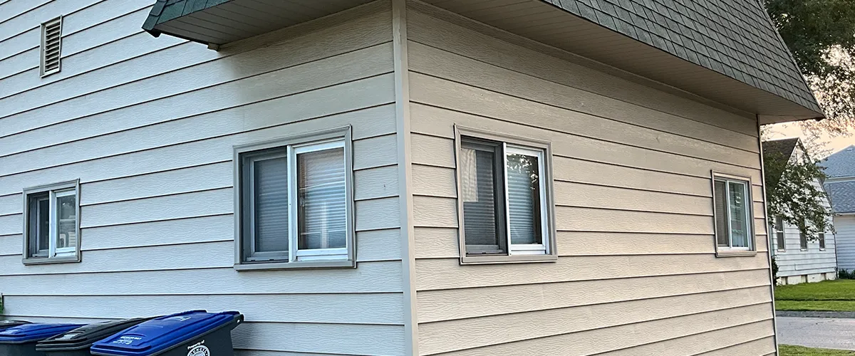 Side view of a residential home with newly installed windows in Council Bluffs