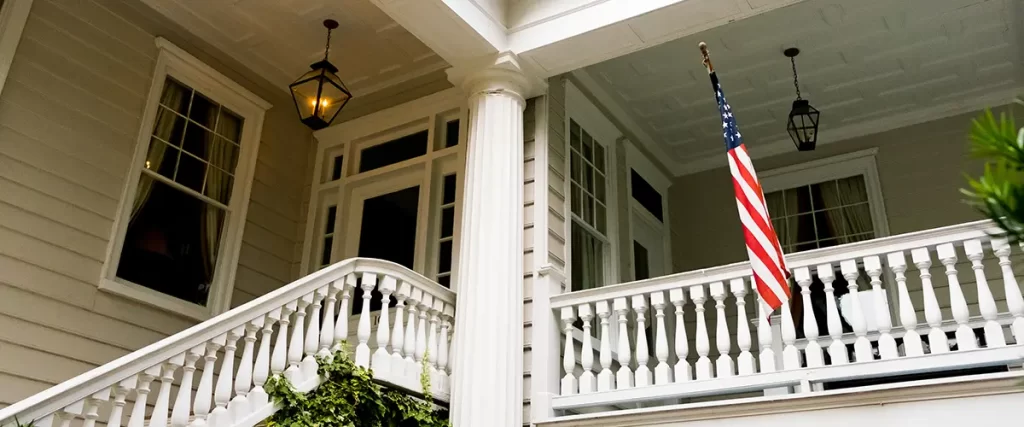 Colonial Revival-style historic home in Dundee, Omaha with porch columns and double-hung windows.