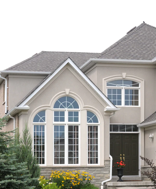Large white arched Palladian windows on a luxury tan stucco home installed by window installation companies in La Vista, NE.